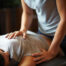 Woman on her stomach getting sports massage to relieve pain after training